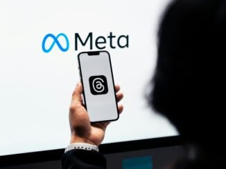 Person holding a phone displaying the Threads social media platform in front of the Meta logo as the company confirms plans to utilise content shared by its adult users in the EU (European Union) on platforms like Instagram and Facebook to train its AI models.